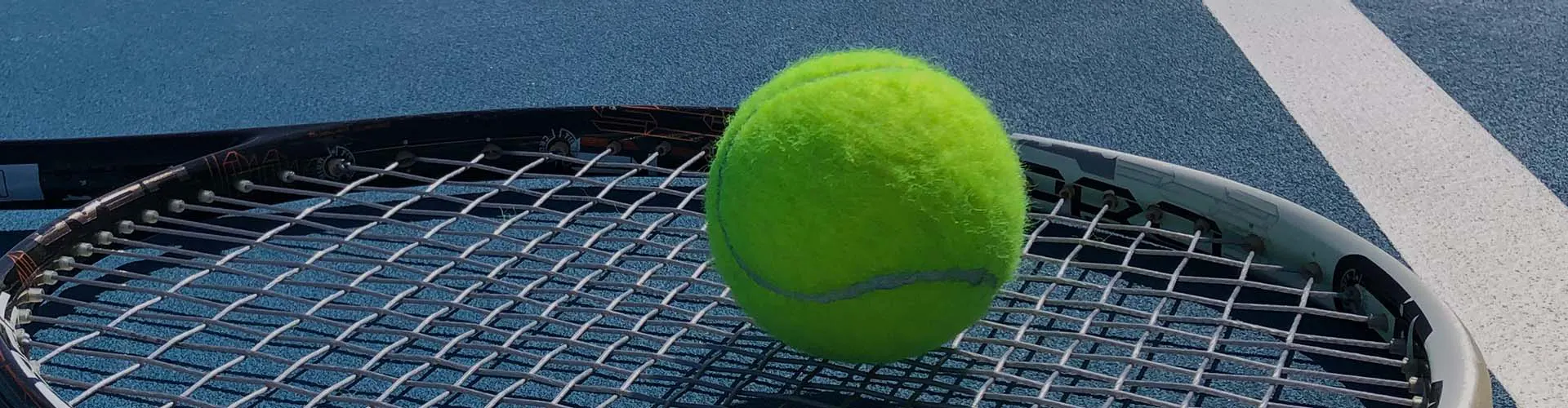 Tennis ball on racquet